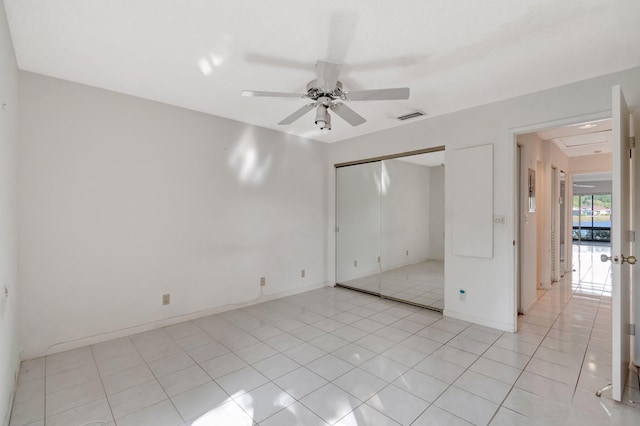 unfurnished bedroom featuring light tile patterned floors and ceiling fan