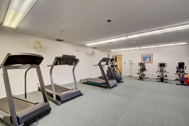 workout area with carpet and a textured ceiling