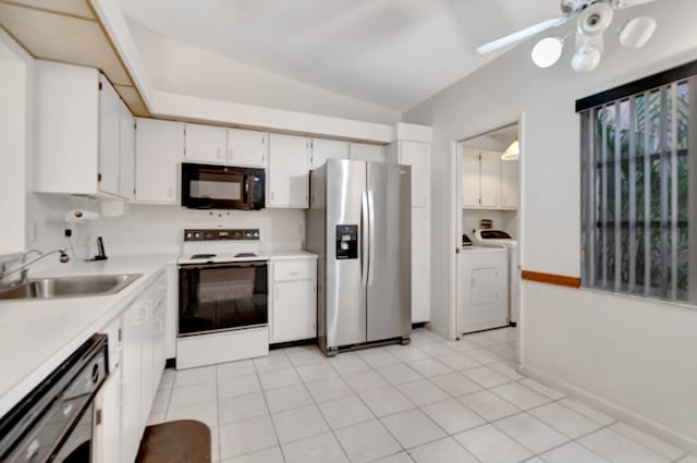 kitchen featuring black appliances, sink, vaulted ceiling, washing machine and dryer, and white cabinetry