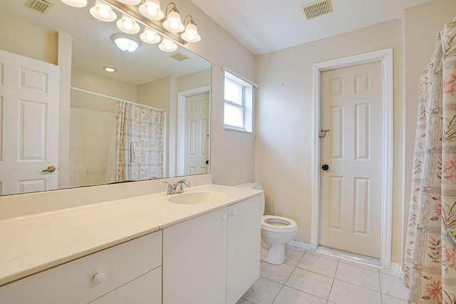 bathroom with a shower with curtain, tile patterned flooring, vanity, and toilet