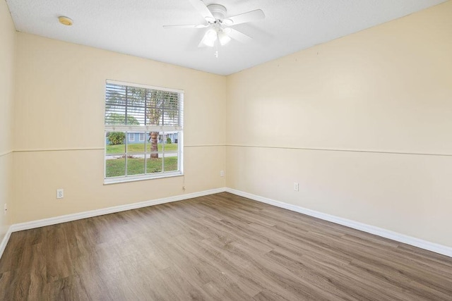 spare room with a textured ceiling, hardwood / wood-style flooring, and ceiling fan