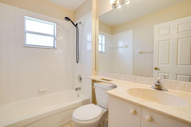 full bathroom featuring vanity, tiled shower / bath combo, and toilet