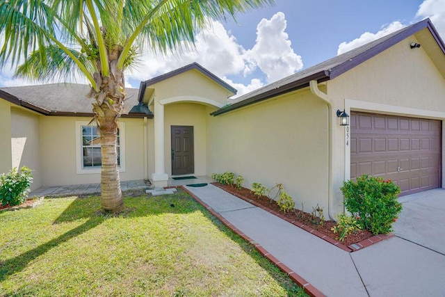 view of front of property with a front yard and a garage