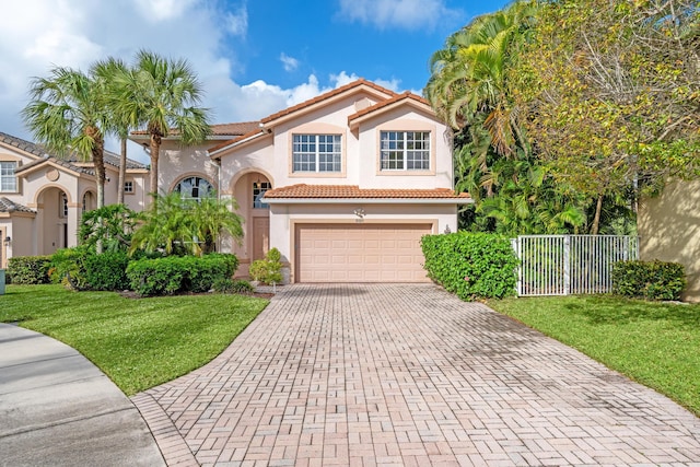 mediterranean / spanish-style home featuring a front yard and a garage