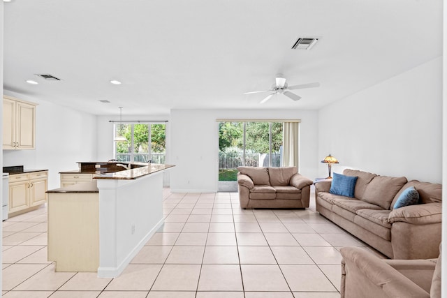 living room with ceiling fan, a healthy amount of sunlight, and light tile patterned flooring