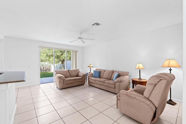 tiled living room with ceiling fan