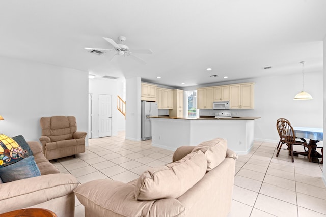 living room featuring light tile patterned floors and ceiling fan