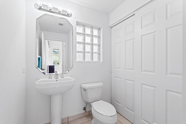 bathroom with sink, tile patterned flooring, and toilet