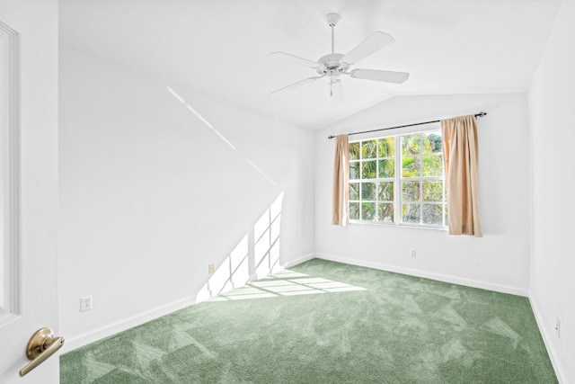 carpeted empty room featuring ceiling fan and vaulted ceiling