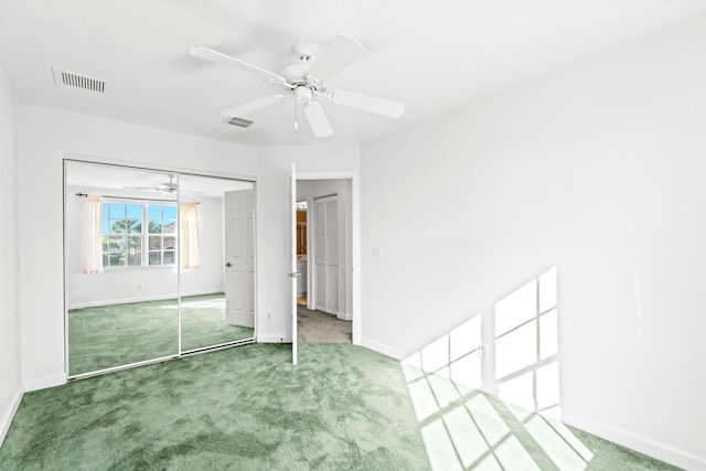 unfurnished bedroom featuring carpet flooring, ceiling fan, and a closet