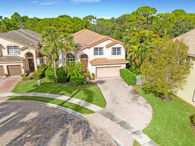 view of front of property with a garage and a front lawn