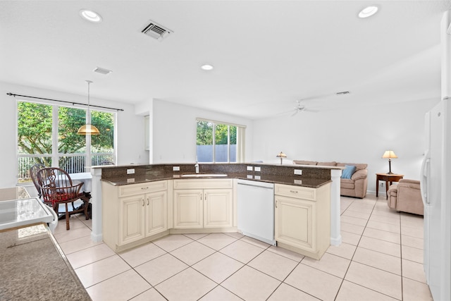 kitchen featuring white appliances, decorative light fixtures, plenty of natural light, and ceiling fan