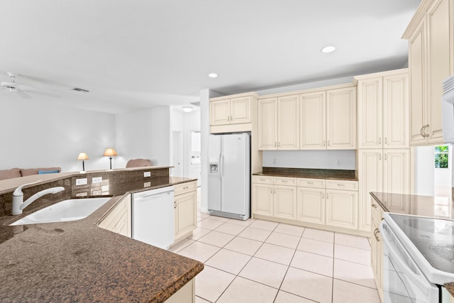 kitchen featuring white appliances, ceiling fan, sink, light tile patterned floors, and cream cabinetry