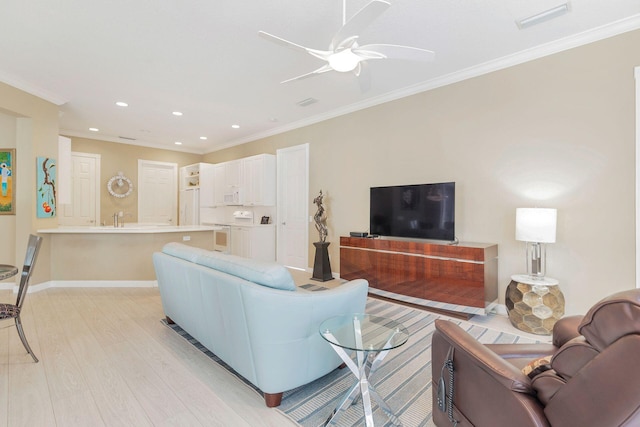 living room with ceiling fan, crown molding, and light hardwood / wood-style flooring