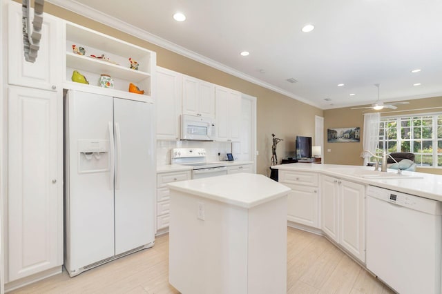 kitchen with white appliances, ceiling fan, light hardwood / wood-style flooring, white cabinets, and a center island