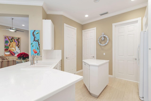 bathroom featuring hardwood / wood-style floors, ceiling fan, ornamental molding, and vanity