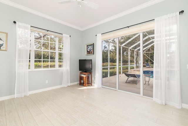 unfurnished living room featuring light hardwood / wood-style flooring, plenty of natural light, ornamental molding, and ceiling fan