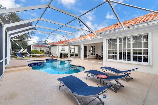 view of pool featuring glass enclosure and a patio