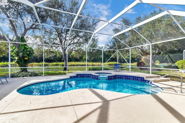 view of pool featuring glass enclosure and a patio