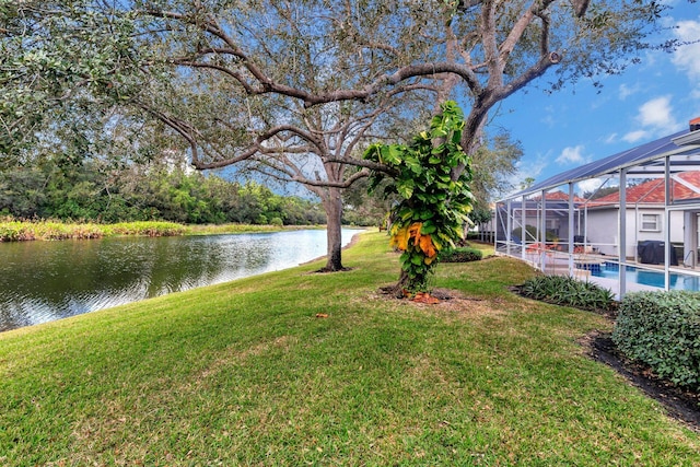 view of yard featuring glass enclosure and a water view