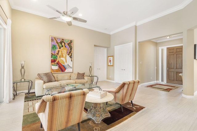 living room with ceiling fan, light wood-type flooring, and crown molding