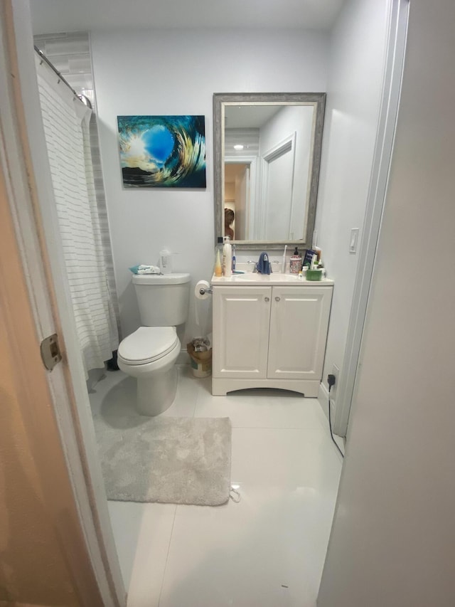 bathroom featuring tile patterned floors, vanity, toilet, and a shower with curtain