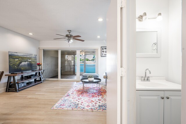 kitchen with sink, stacked washer / dryer, white fridge, cream cabinetry, and light tile patterned floors