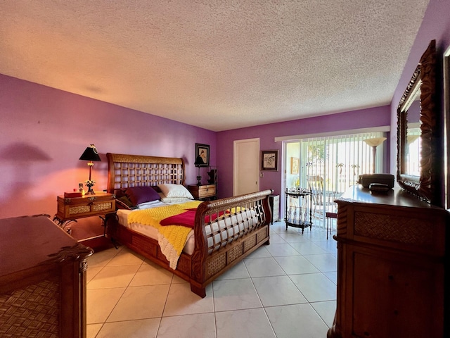 bedroom with light tile patterned floors and a textured ceiling