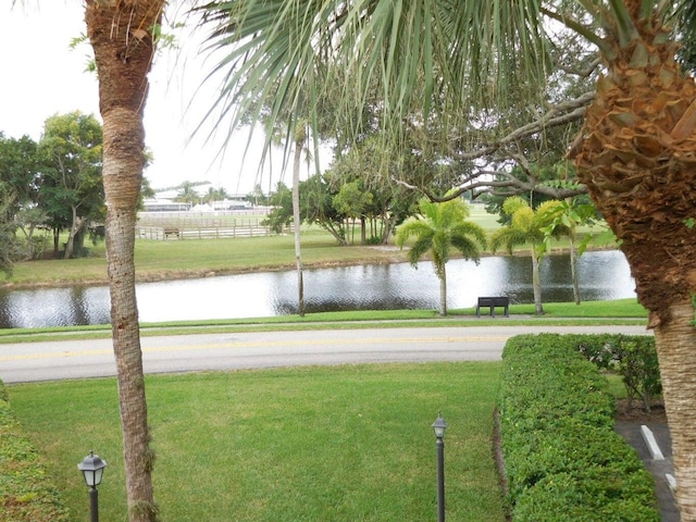 view of property's community featuring a yard and a water view