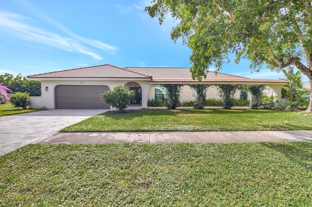 view of front of property with a front yard and a garage