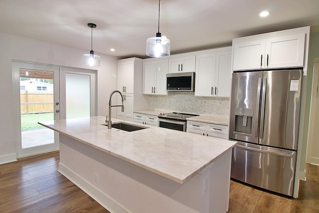 kitchen featuring white cabinets, sink, stainless steel appliances, and a kitchen island with sink