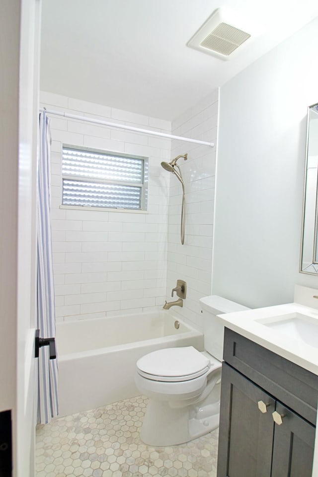 full bathroom with vanity, toilet, and shower / tub combo