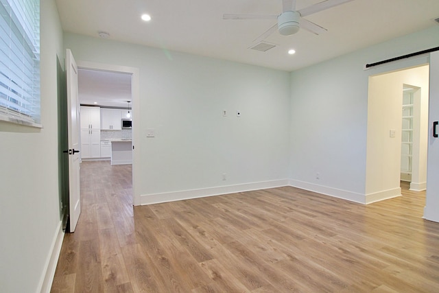 spare room with ceiling fan and light hardwood / wood-style flooring