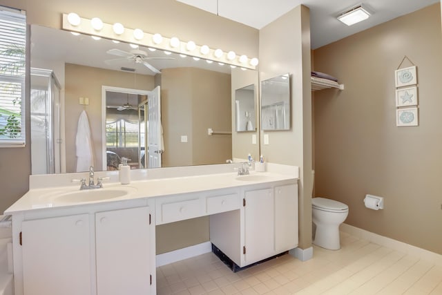 bathroom with tile patterned flooring, vanity, ceiling fan, and toilet