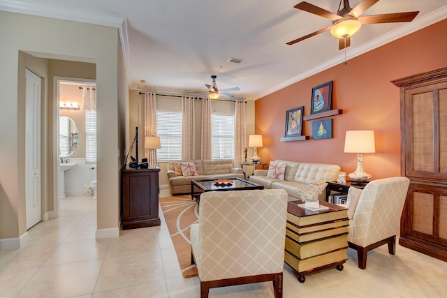 living room featuring ceiling fan, ornamental molding, and light tile patterned flooring