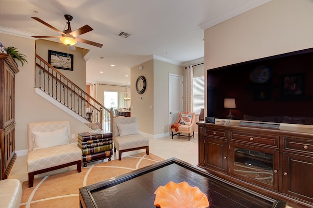 living room with ceiling fan and ornamental molding