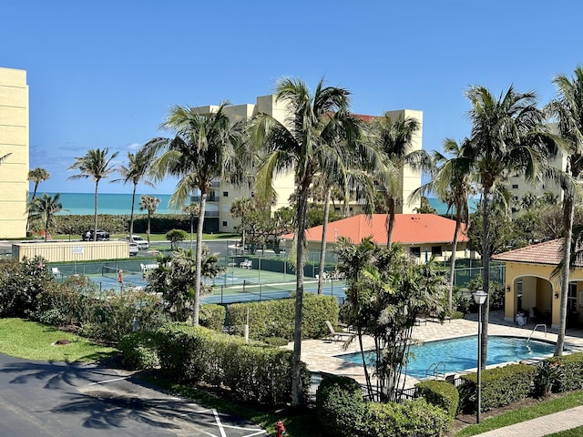 view of pool featuring tennis court