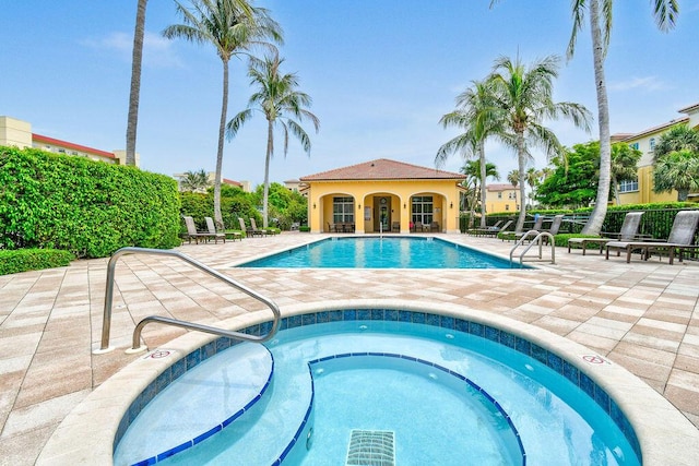 view of swimming pool with a community hot tub and a patio