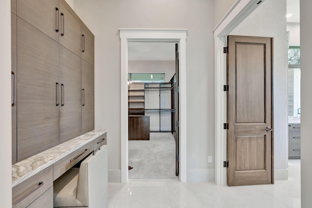 hall featuring light tile patterned floors