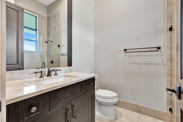 bathroom featuring toilet, an enclosed shower, and vanity