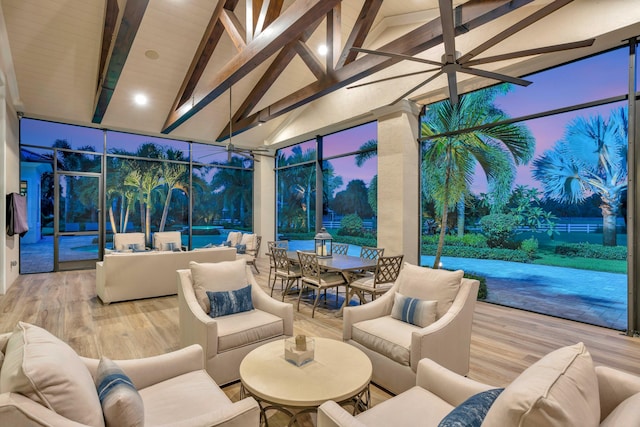 sunroom / solarium featuring vaulted ceiling with beams and ceiling fan