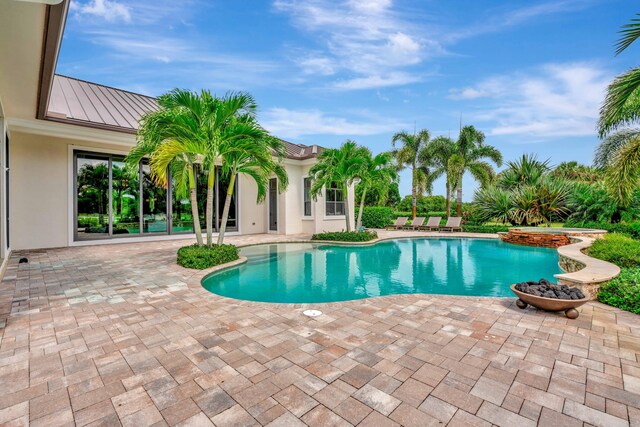 view of swimming pool with a patio area and an in ground hot tub