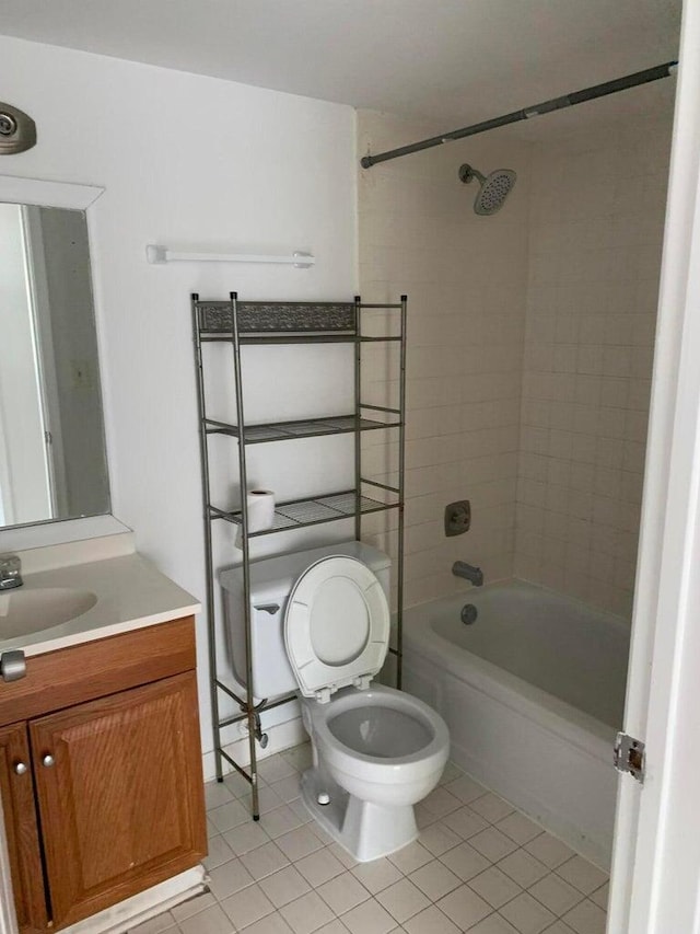 full bathroom featuring tile patterned floors, vanity, tiled shower / bath combo, and toilet