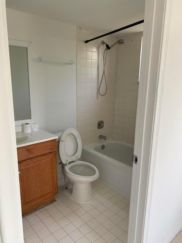 full bathroom featuring tile patterned floors, vanity, toilet, and tiled shower / bath