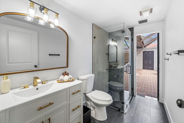 bathroom with vanity, toilet, and a shower with door