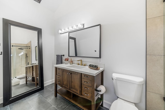 bathroom with vanity, toilet, and tiled shower