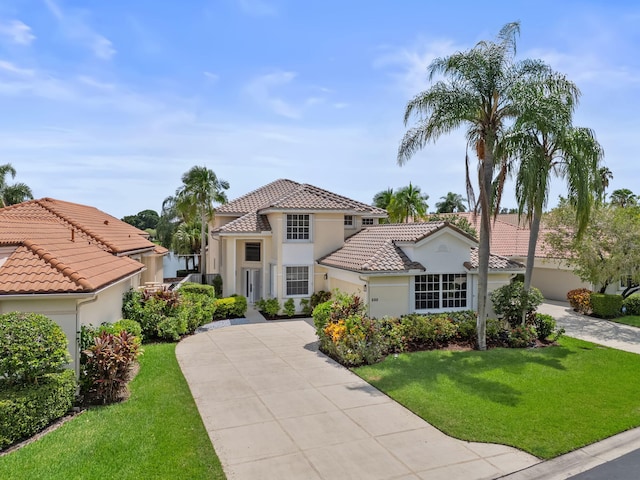 mediterranean / spanish-style home featuring a front yard