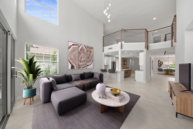 living room with a notable chandelier and a high ceiling