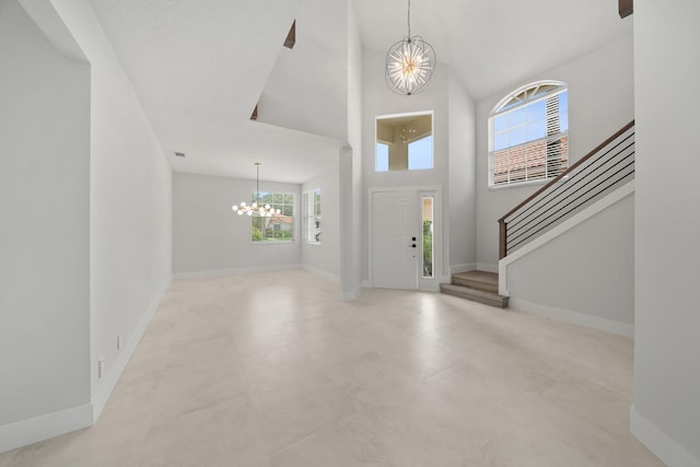 foyer with a towering ceiling and an inviting chandelier