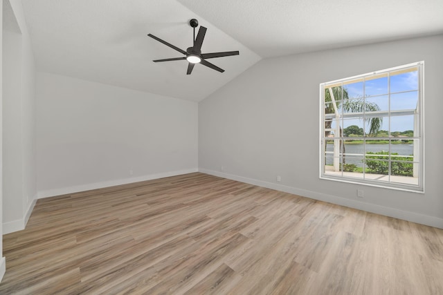 interior space featuring ceiling fan, light wood-type flooring, a textured ceiling, and vaulted ceiling